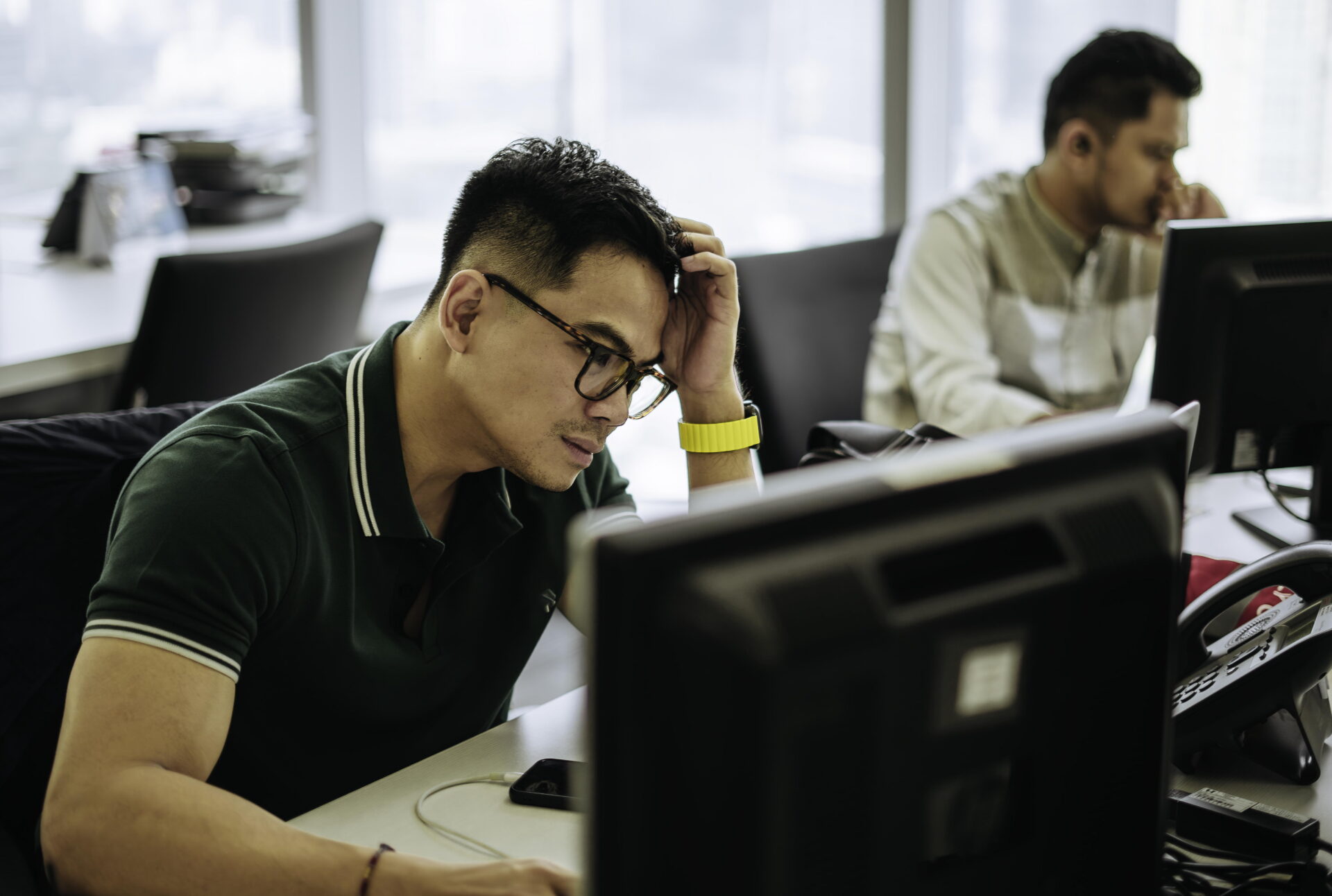 Shot of a young business people looking stressed while working in a modern office