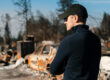 A man visiting the scene of a disaster
