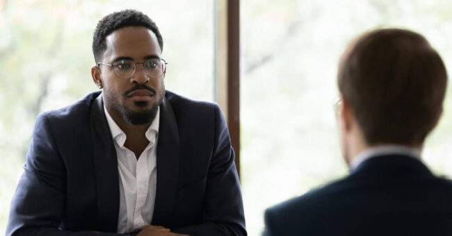 Featured Image – Addressing Harassment Two co-workers discussing and listening to each other