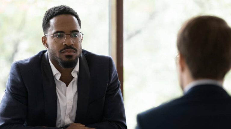 Featured Image – Addressing Harassment Two co-workers discussing and listening to each other