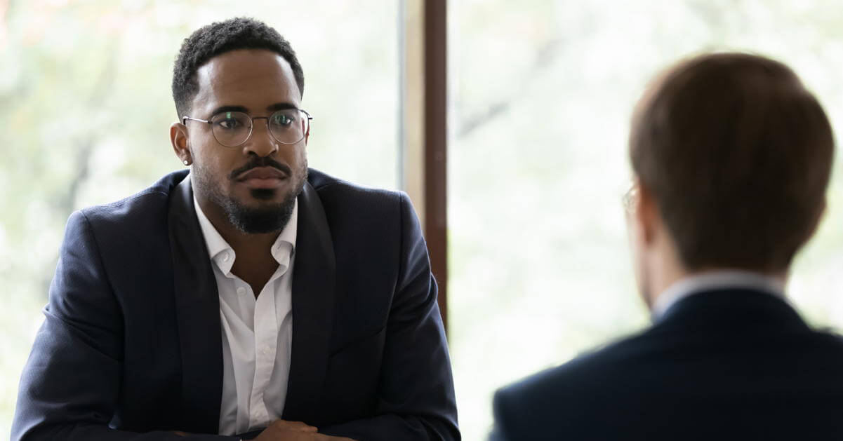 Featured Image – Addressing Harassment Two co-workers discussing and listening to each other