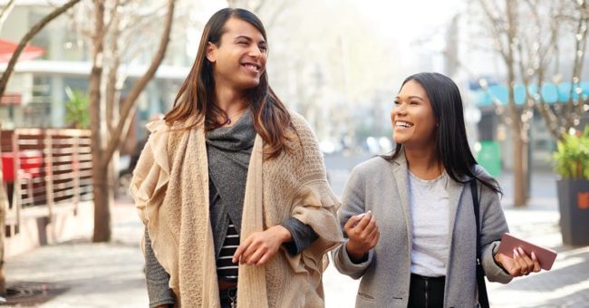 Being-Transgender-Ally Cropped shot of two affectionate young friends having a discussion while walking in the city