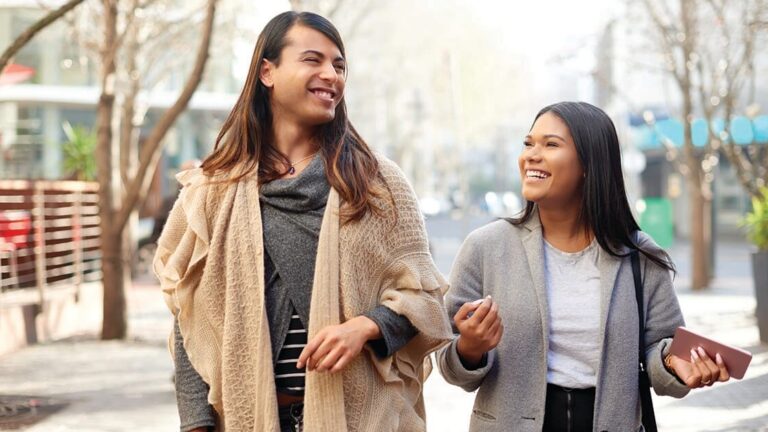 Being-Transgender-Ally Cropped shot of two affectionate young friends having a discussion while walking in the city