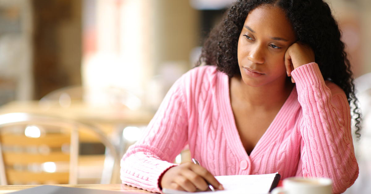 Black distracted apathetic student in a coffee shop