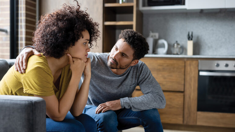 Blog Featured Image – Help for Anxiety African American man comforting his girlfriend at home while she is looking upset - lifestyle concepts