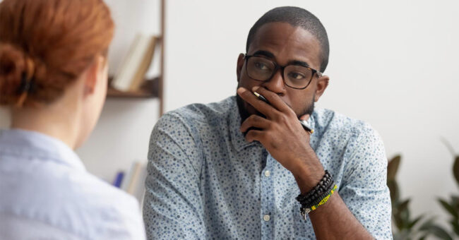 Blog Featured Image – How Do I Say That? Out-of-Character Behavior Doubtful unconvinced african american hr manager talking to caucasian applicant at job interview feeling skeptic rejecting seeker skill, bad first impression, lack of experience or failed performance