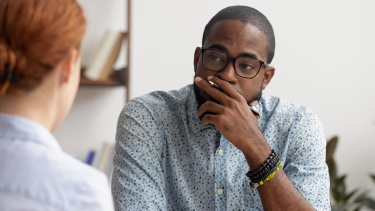 Blog Featured Image – How Do I Say That? Out-of-Character Behavior Doubtful unconvinced african american hr manager talking to caucasian applicant at job interview feeling skeptic rejecting seeker skill, bad first impression, lack of experience or failed performance