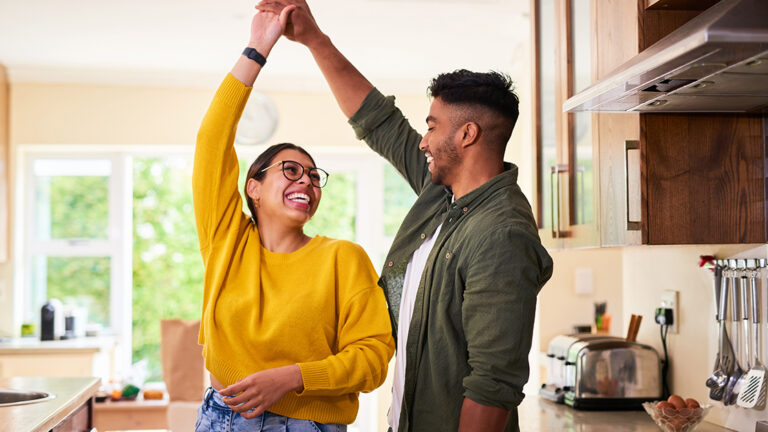 Blog Featured Image_Building Strong Relationships Shot of a young couple dancing together in their kitchen