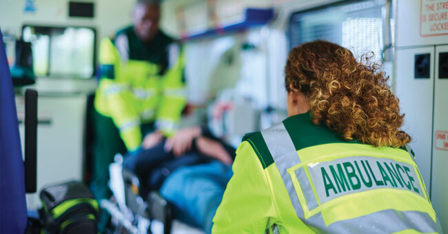 Ambulance crew preparing casualty