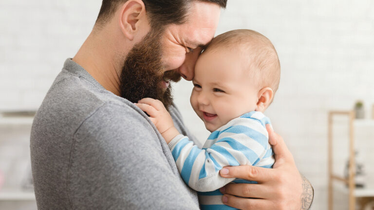 Mindful Gratitude Loving father embracing his cute baby son