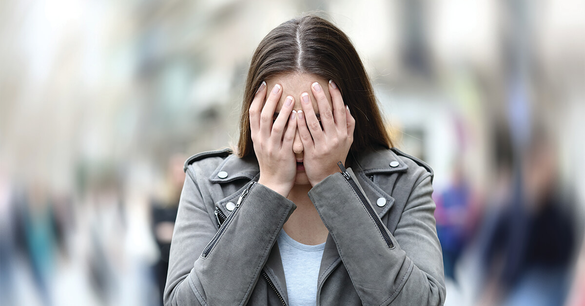 Woman suffering anxiety attack on city street