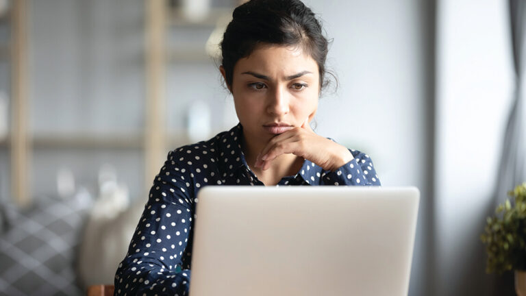 Blog Featured Image_Supporting Others in a Time of Need Serious frowning indian woman read email on laptop feels concerned