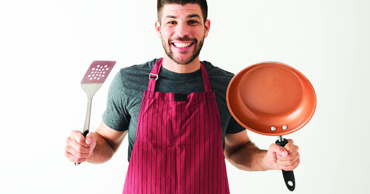 Young man is excited to cook dinner with his new cookware set