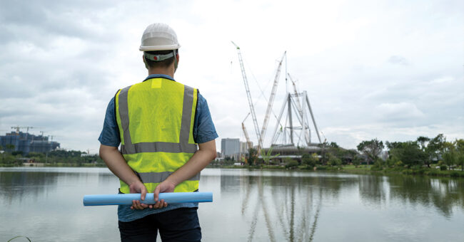 Creating a Safer Workplace A young Asian male engineer working at a construction site