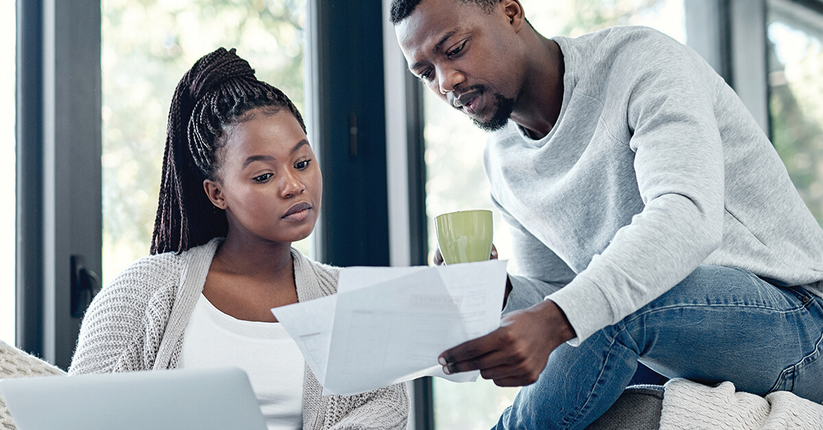 Shot of a young couple going through paperwork at home