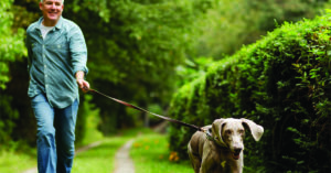 Man walking his dog on a trail