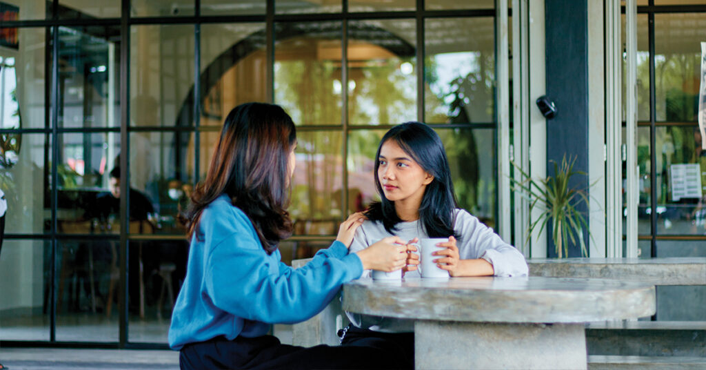 Two asian best friend having conversation together and supporting each other. Mental health.