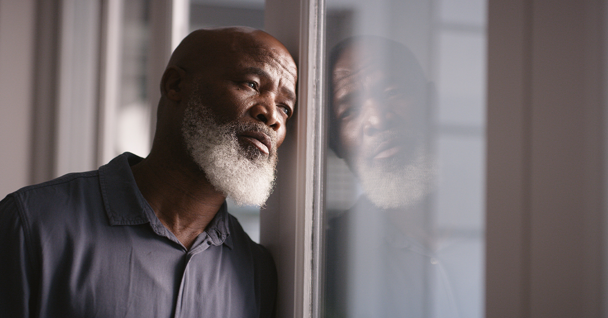 Sad, depression or black man burnout at window with mental health, headache or anxiety in house. Lonely, stress or depressed man thinking for financial problem, health compliance or finance policy