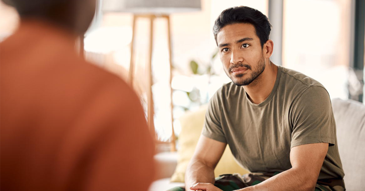 Featured Image – Episode 31 – Uplifting Suicide Awareness with Mark and Sarah Moss, Part Two Listen, therapy and a military man with a psychologist for counselling, support and psychology. Young army, veteran or soldier person on therapist couch for mental health, consultation or help