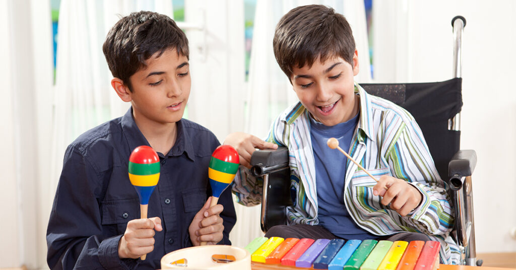 Disabled little boy in a music class, music therapy