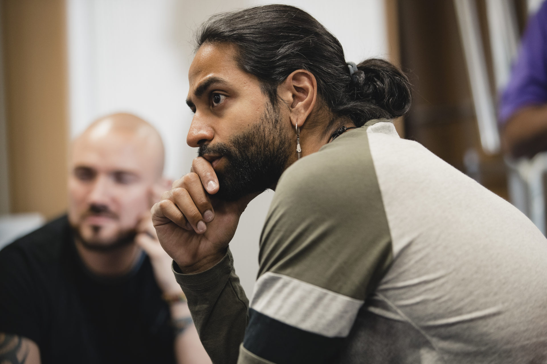 man listening resting head in hand