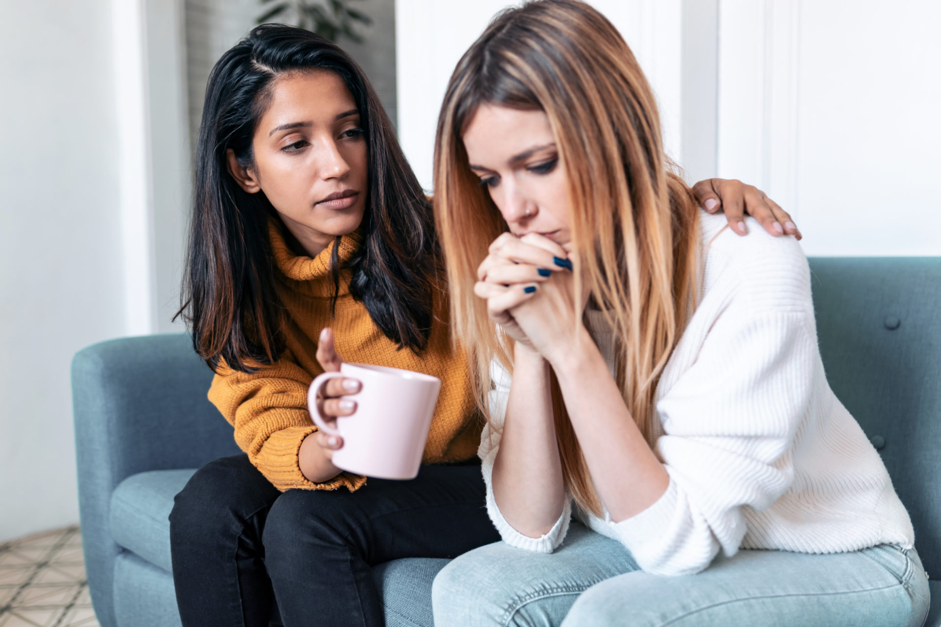 one woman consoling another