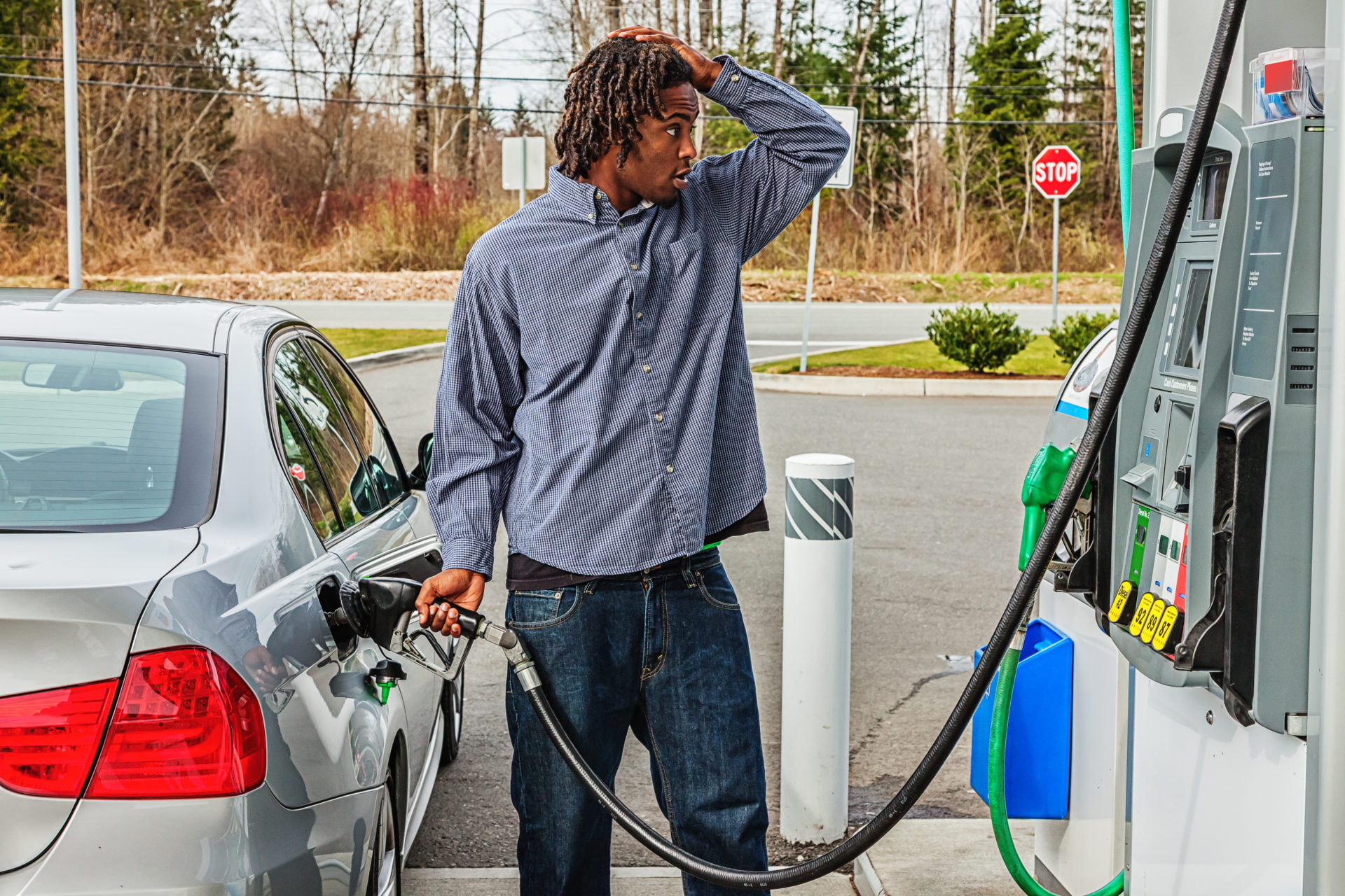 man frustrated pumping gas