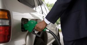 Close up of person pumping gas into SUV