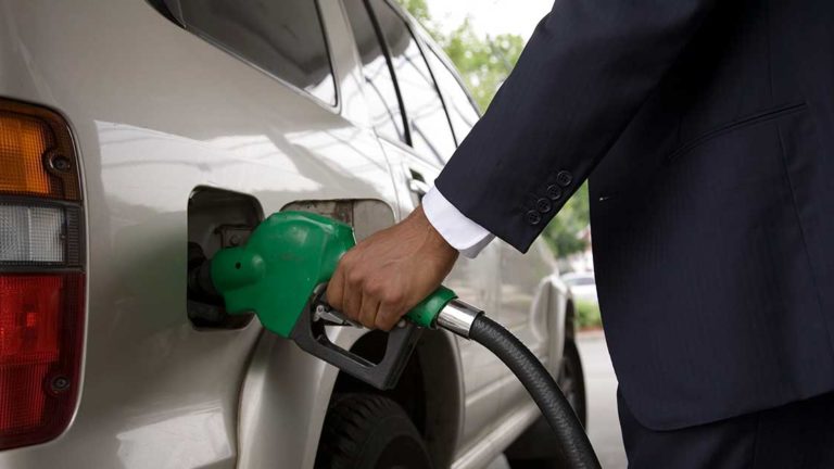 Close up of person pumping gas into SUV Close up of person pumping gas into SUV
