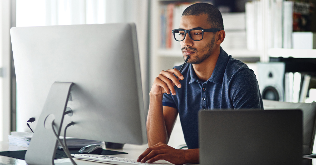 Cropped shot of a businessman using his computer in his home office