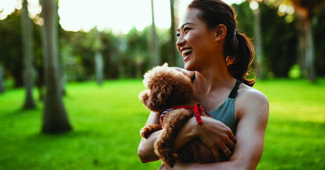 Maintaining Your Emotional Wellbeing Beautiful Taiwanese sport woman with dog in the park