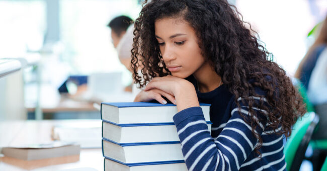 Podcast Featured Image – Episode 56 College student that's scared of school resting her head on textbooks