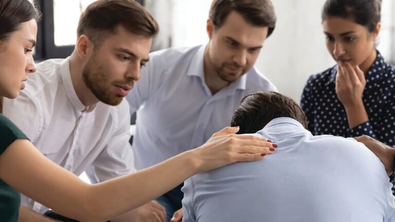 Providing-Support-After-Loss Diverse group giving comfort and support to upset mate