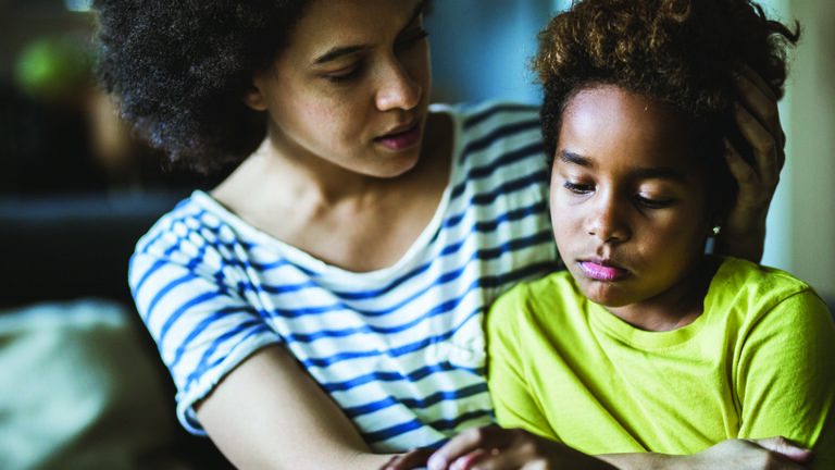 Talking to Children About Violence African American mother consoling her sad girl at home.