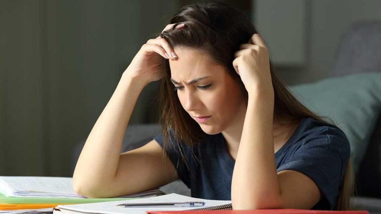 Studious student memorizing notes late hours Studious student memorizing notes late hours