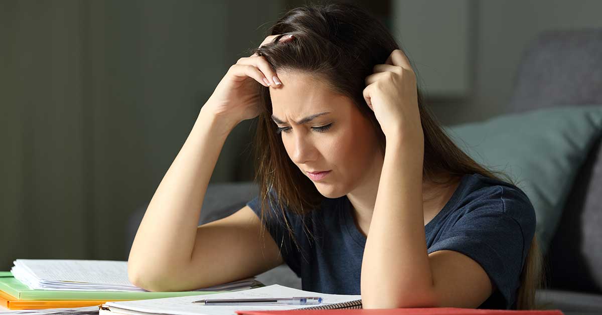 Studious student memorizing notes late hours Studious student memorizing notes late hours