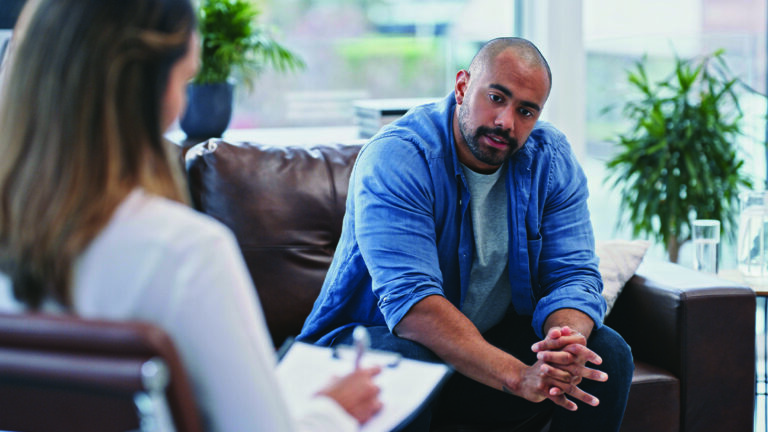 Workplace Alcohol or Drug Use Cropped shot of a handsome young man looking thoughtful while sitting in session with his female therapist