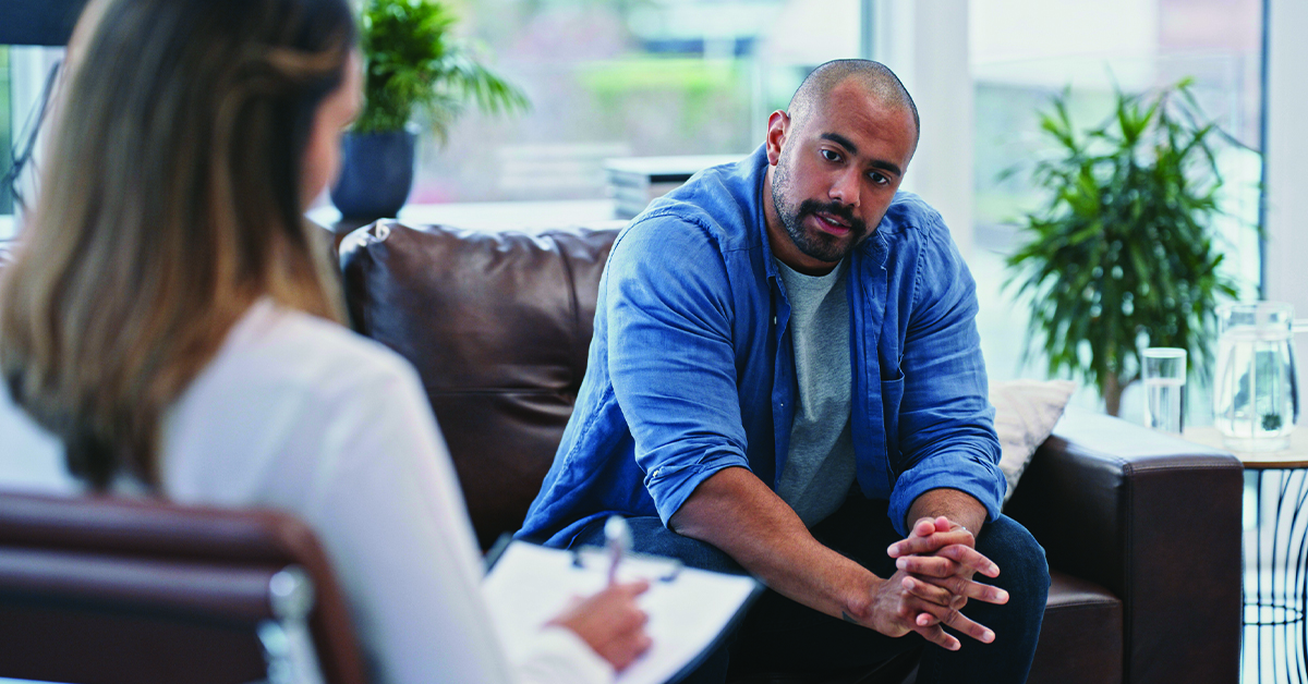 Cropped shot of a handsome young man looking thoughtful while sitting in session with his female therapist