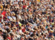 Blurred out people attending an event at an outdoor stadium