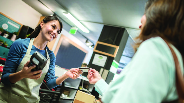 breaking-bad-money-habits Cashier at the supermarket getting a card payment