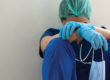 Stressed tired healthcare worker sitting on floor