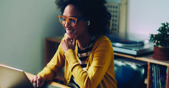 out-of-sorts-just-smile-featured-image Working from home in the era of the new normal: a happy mixed race woman attending an online meeting.