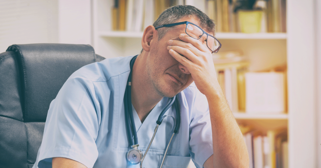 physicians-alcohol-worrisome-pattern-featured-image Overworked doctor sitting in his office