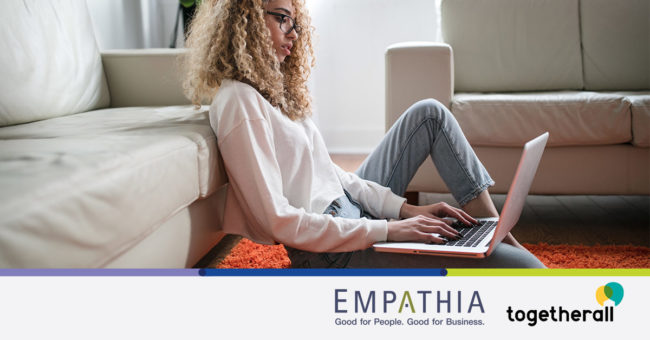 togetherall-press-release Woman typing on a computer with a concerned look on her face.