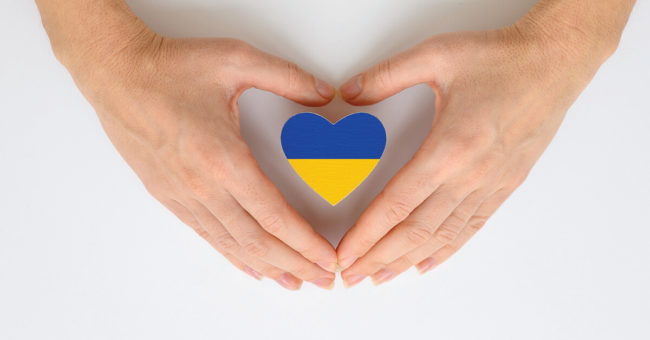 violence-in-ukraine-featured-image The national flag of Ukraine in female hands. The concept of patriotism, respect and solidarity with the citizens of Ukraine