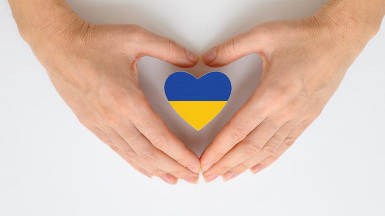 violence-in-ukraine-featured-image The national flag of Ukraine in female hands. The concept of patriotism, respect and solidarity with the citizens of Ukraine