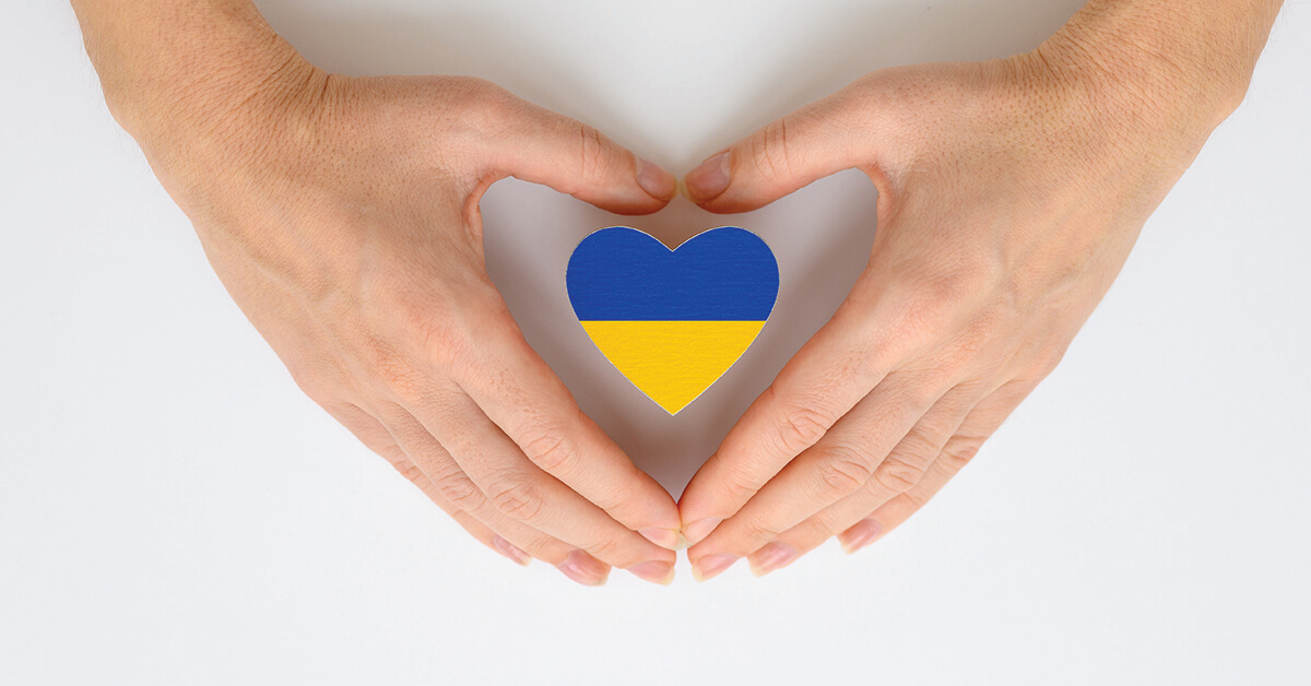 violence-in-ukraine-featured-image The national flag of Ukraine in female hands. The concept of patriotism, respect and solidarity with the citizens of Ukraine